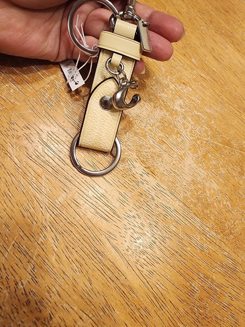 Coach Trigger Snap Bag Charm in Signature Canvas featuring a sleek Beige/silver